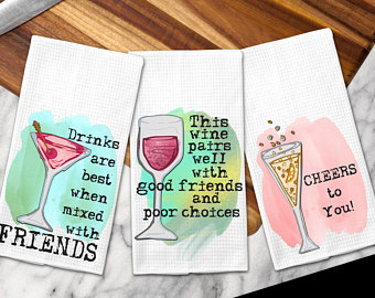 three white dish towels with fun wine related sayings