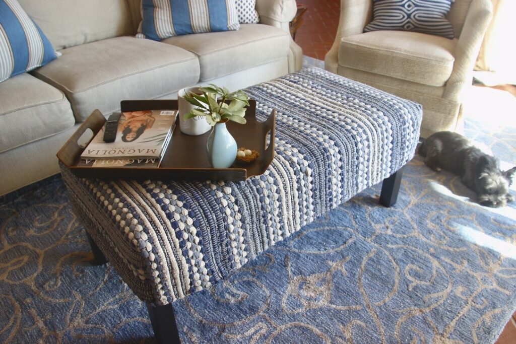 finished ottoman with dog looking at it from his sunbeam on the floor