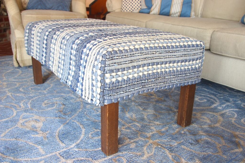 finished slipcover on ottoman, but with ugly scratched brown legs