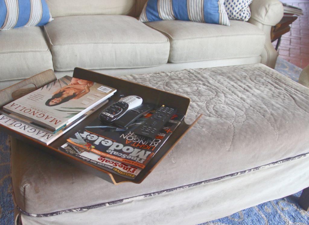 Lats version of ottoman with tray of magazines