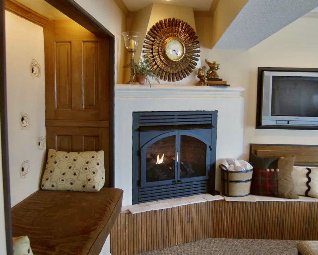 view of new faux concrete fireplace surround with the sunburst clock