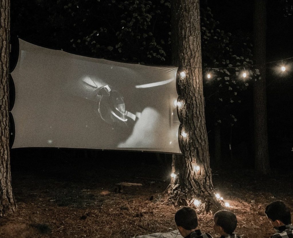 Outdoor movie setup between trees