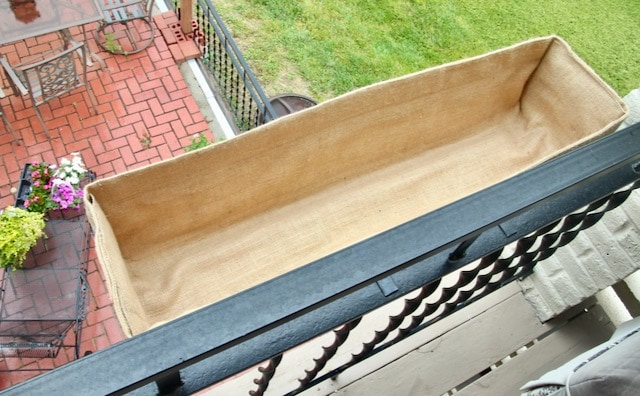 view of the inside of the planter liner in the planter hanging on the railing