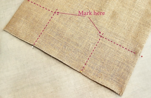 imaginary lines on burlap meeting to show where to mark for corners
