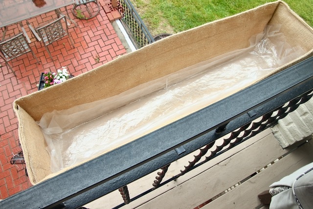 view inside new custom planter box liner with a sheet of plastic covering the bottom