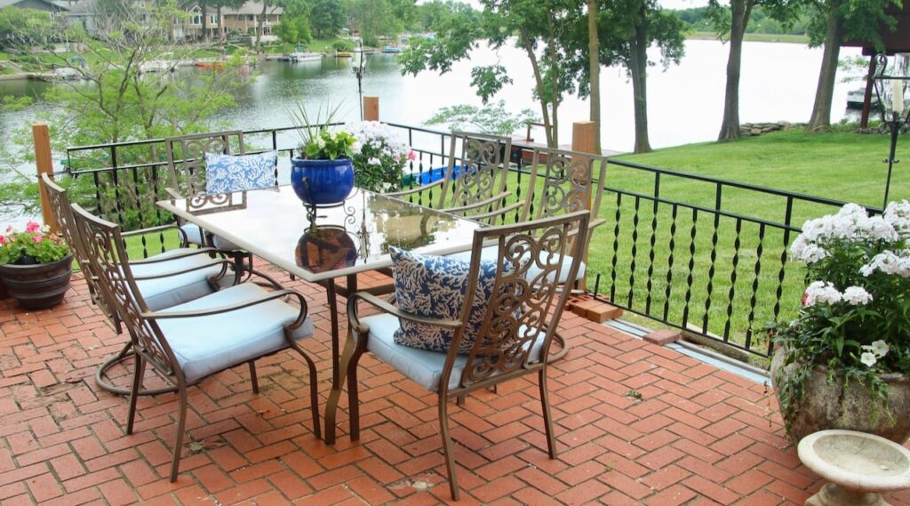 Large dinner table and 6 chairs on brick patio