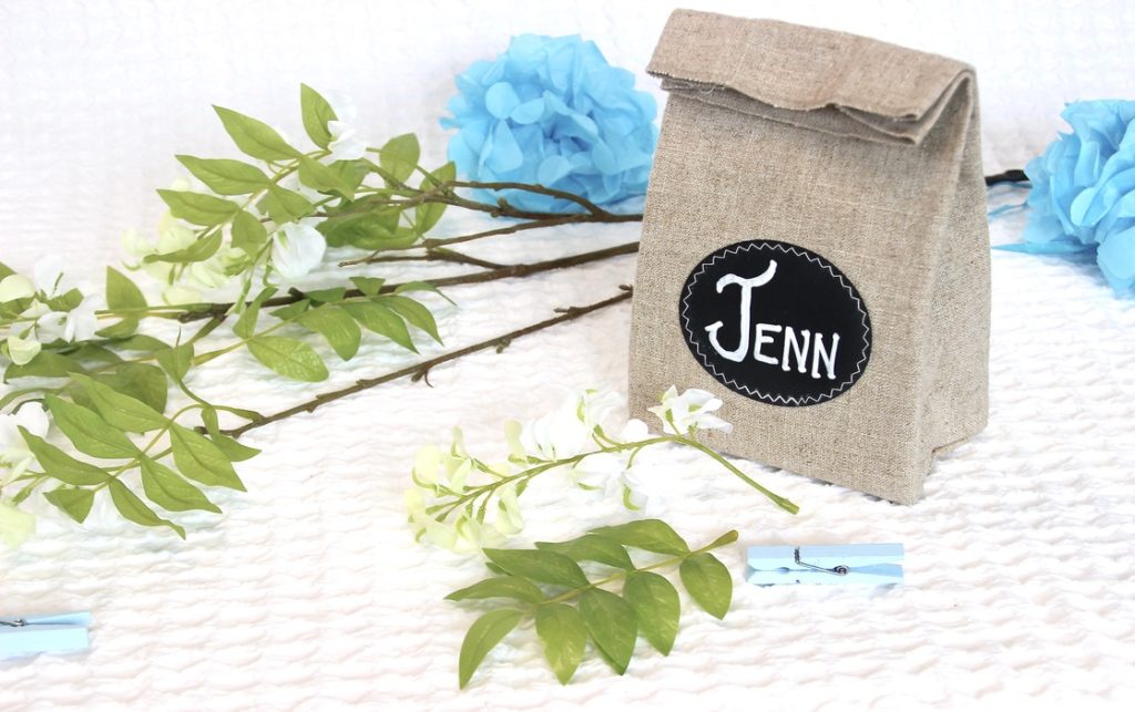 Linen personalized party favor bag waiting to be styled with the wisteria and clothespin