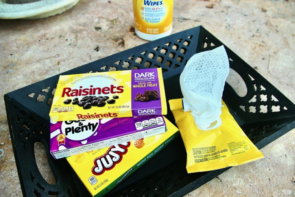 Tray of movie snack boxes and sanitizing wipes for safe get together movie night