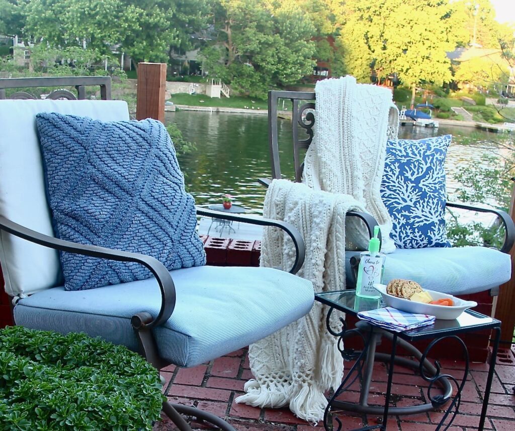 Two chairs and table with individual snack tray and hand sanitizer to safely get together after sheltering in place