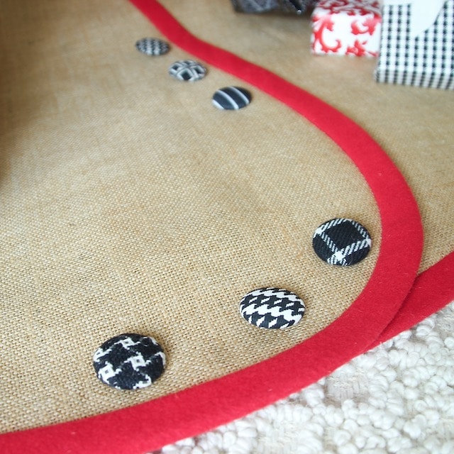 Closeup of Burlap Christmas Tree Skirt with Bright Red Banding and Black & White BUttons