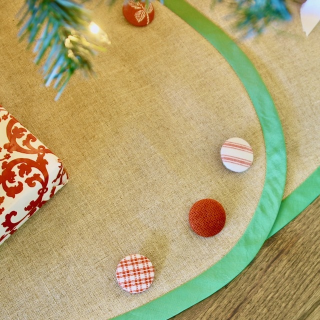 Closeup of Christmas Tree Skirt with Festive Green Taffeta Banding and Red & White Buttons