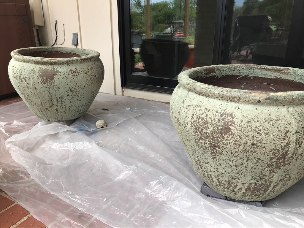 Pair of large textured pottery patio pots empty and waiting to be transformed.
