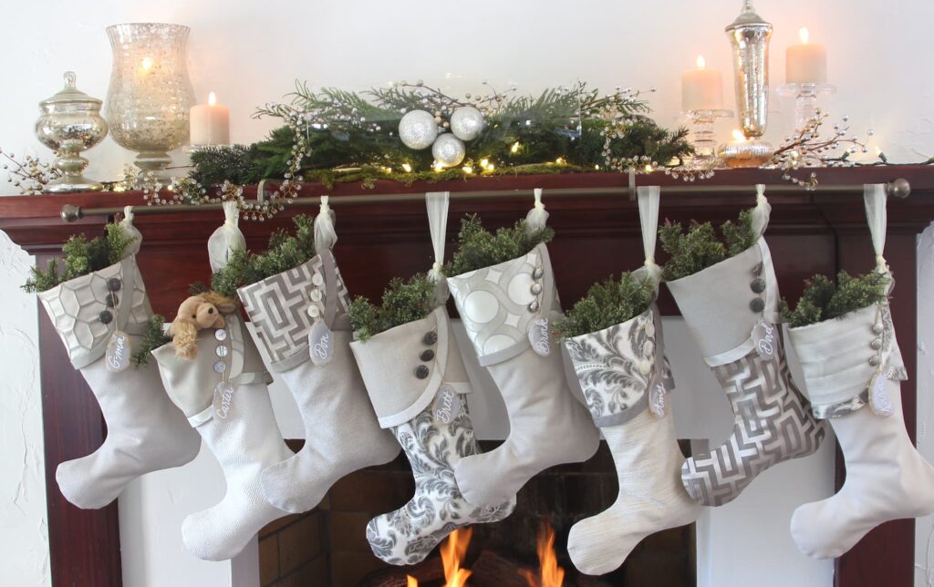 Set of eight silver Christmas stockings hanging on a mahogany mantel