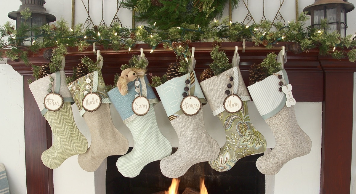 six coastal cottage christmas stockings with white tree slice name tags