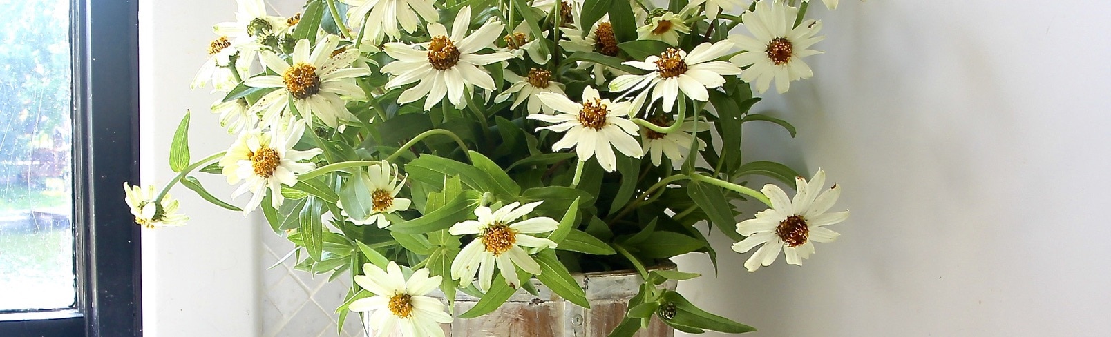 Closeup of table runner woven into wreath on brick wall