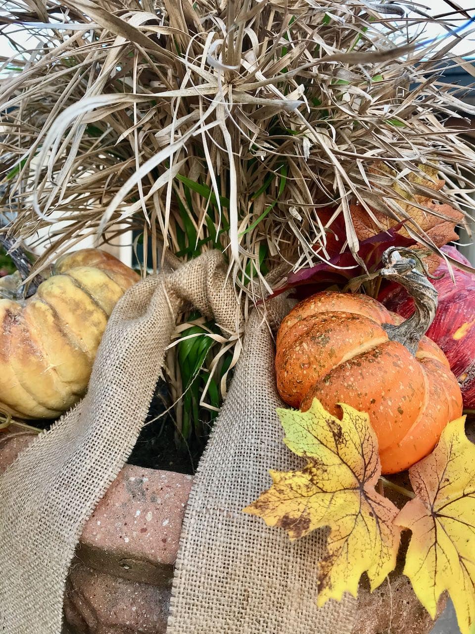 The other planter with more pumpkins and leaves and the burlap ribbon tails