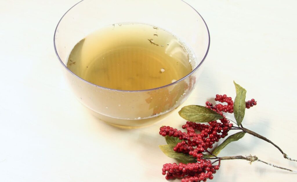 Clear bowl of very dirty water used to clean dusty berry stems