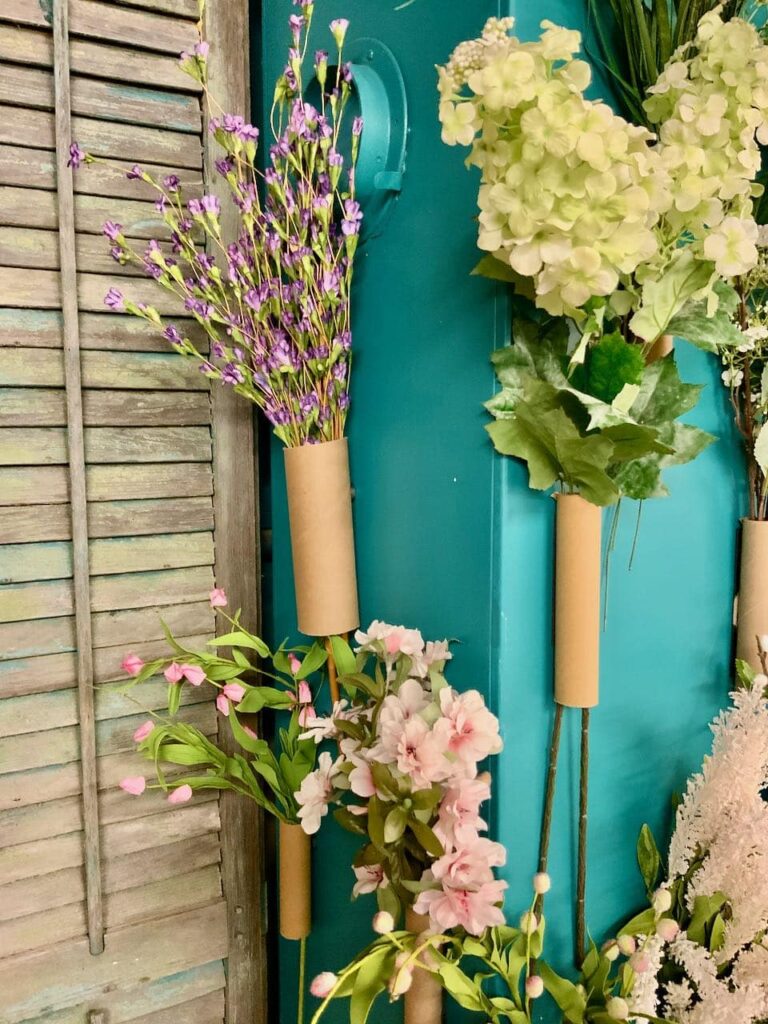 Closeup of floral stems in cardboard tubes on side of HVAC unit