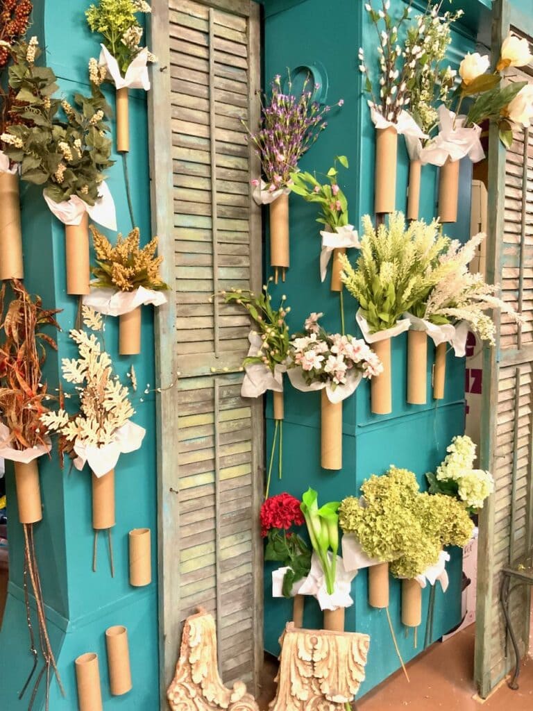 Large sides of HVAC unit covered in tubes holding faux florals