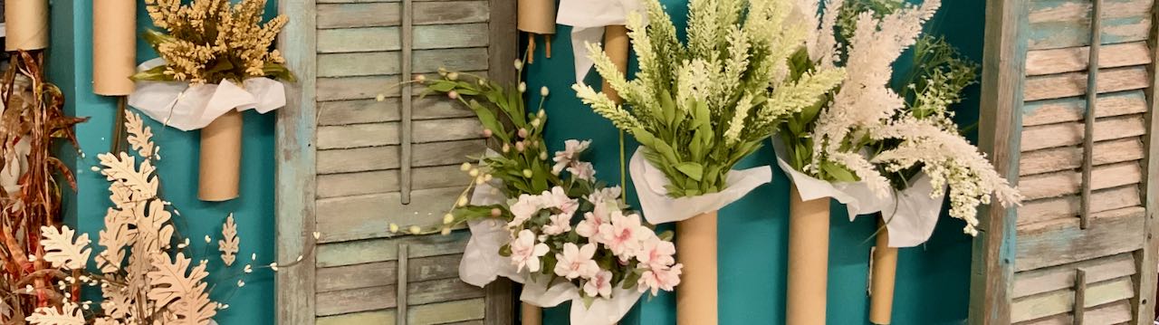 closeup of florals in cardboard tubs on side of HVAC unit