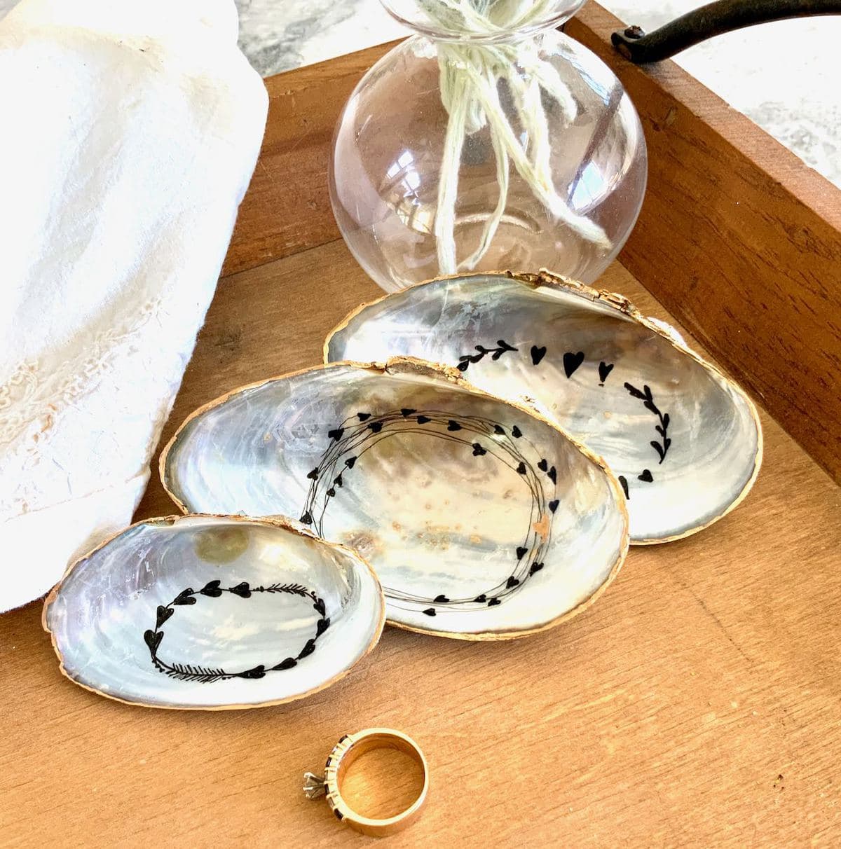 3 shell ring dishes on wood tray with gold ring