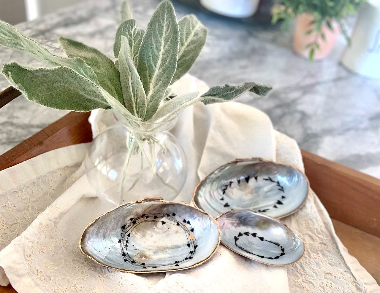 Three shell trinket dishes on linen napkin