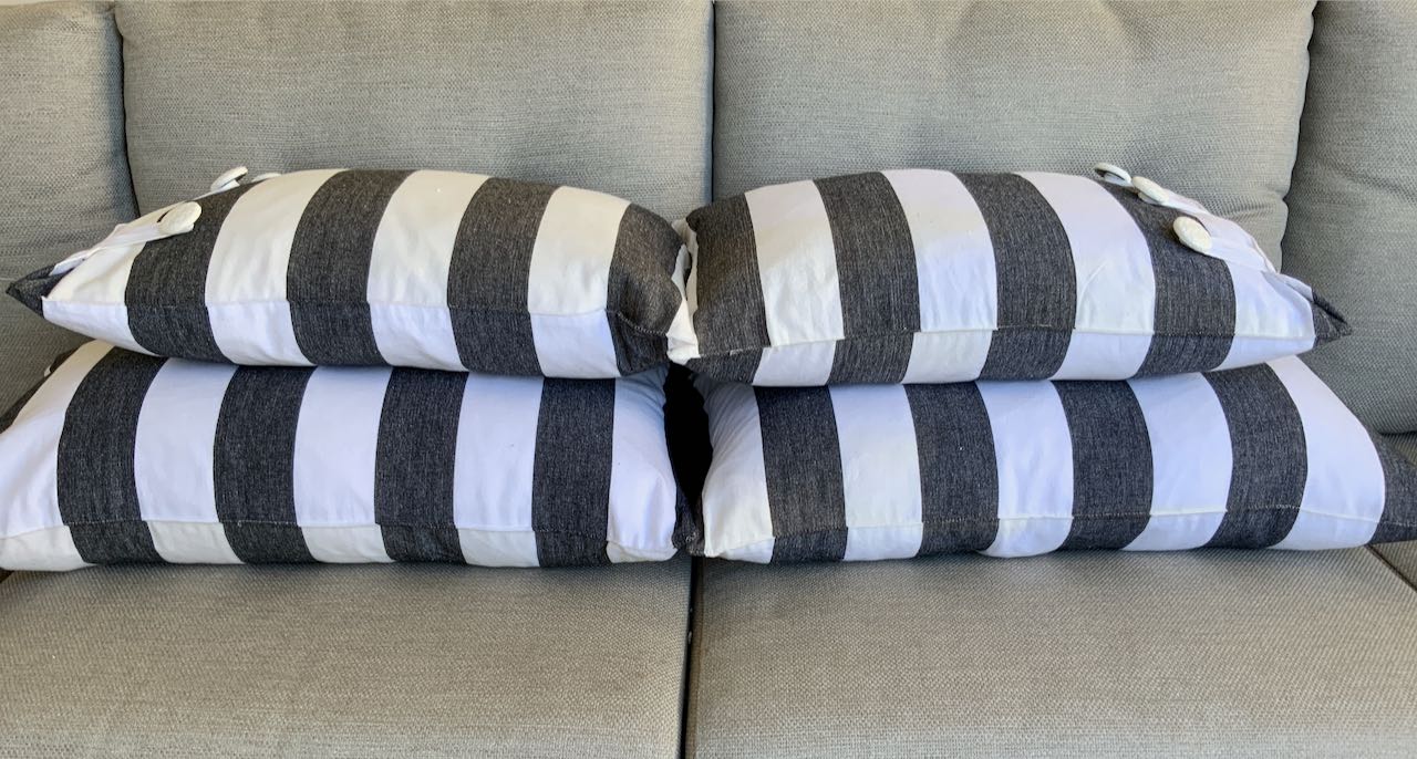 Four Cabana stripe pillows stacked on an outdoor sectional