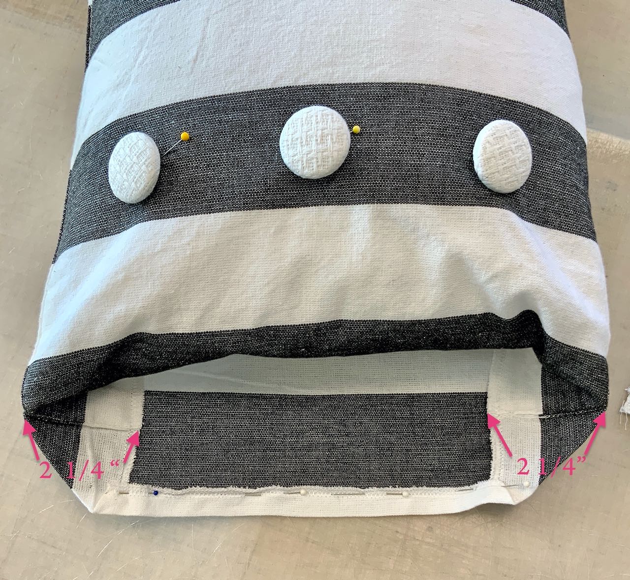 showing the open end of the pillow with the top tucked an and under the form and the corners poked in evenly