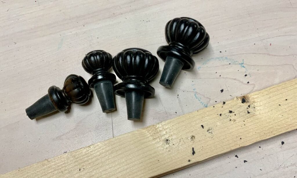 Four finished finials mounted on the stoppers