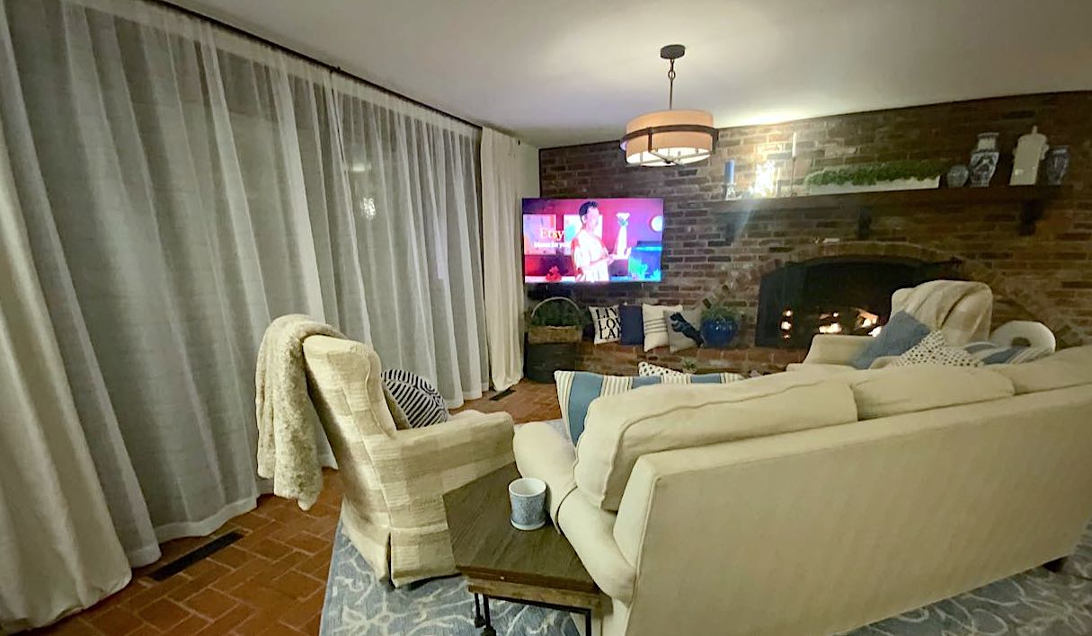 Full view of family room with sheers of sliding glass doors at night