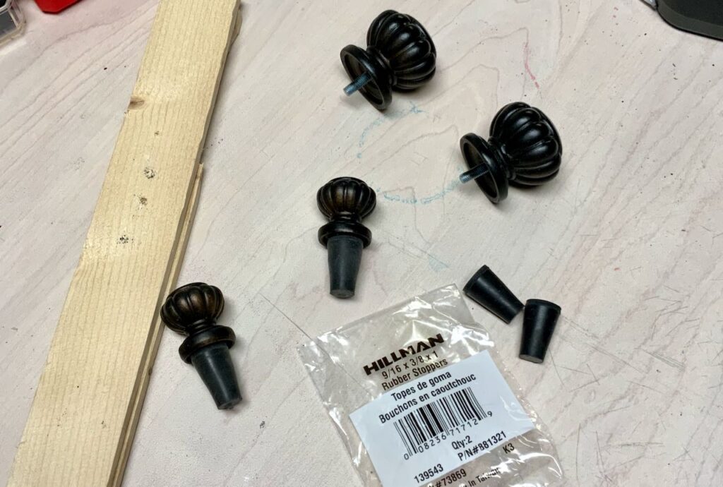 Four rubber stoppers and four finials in process