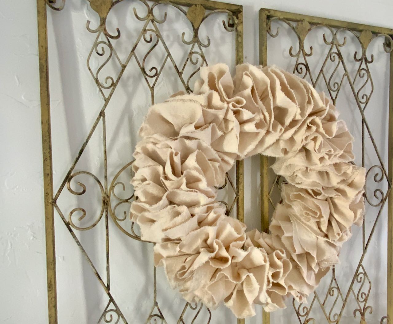 Wreath wired to two ornate trellises