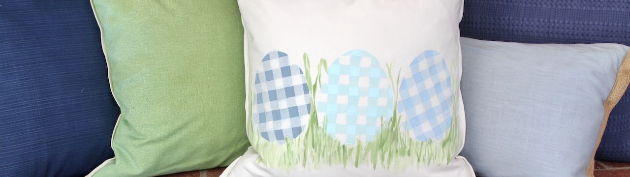 Super closeup of painted plaid eggs with pillows on fireplace hearth