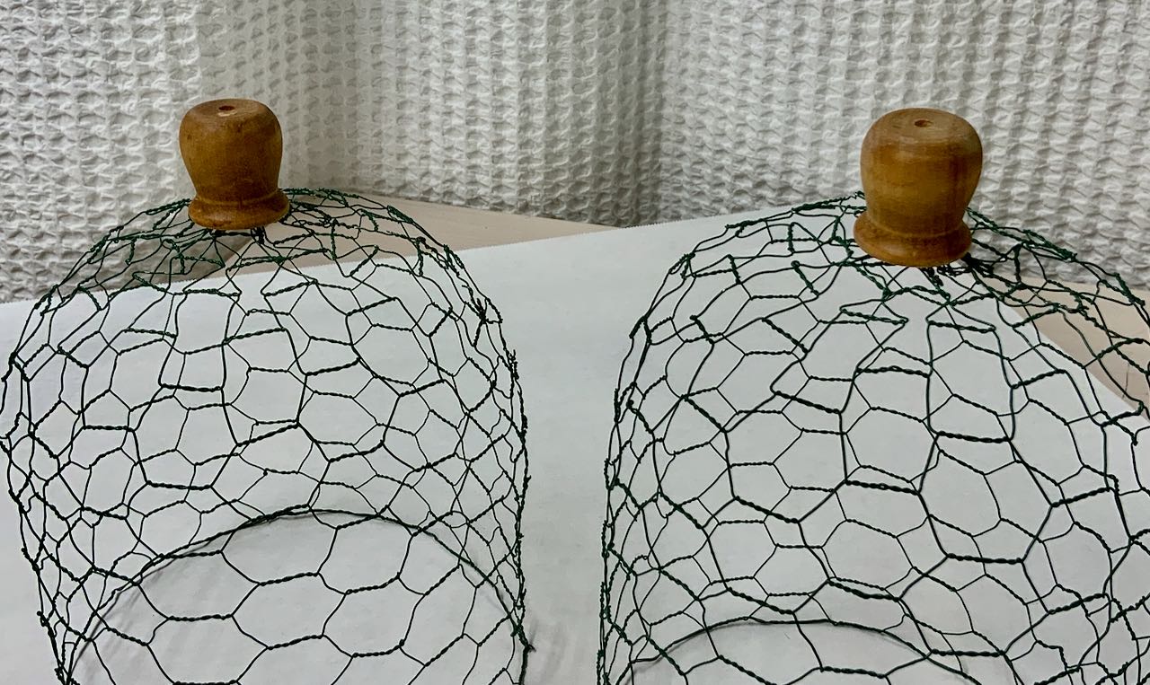 Two Wire Cloches up close with wood handles on top