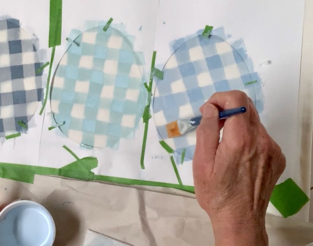 Hand holding a paintbrush and swiping from the edge of the egg frame into a solid square