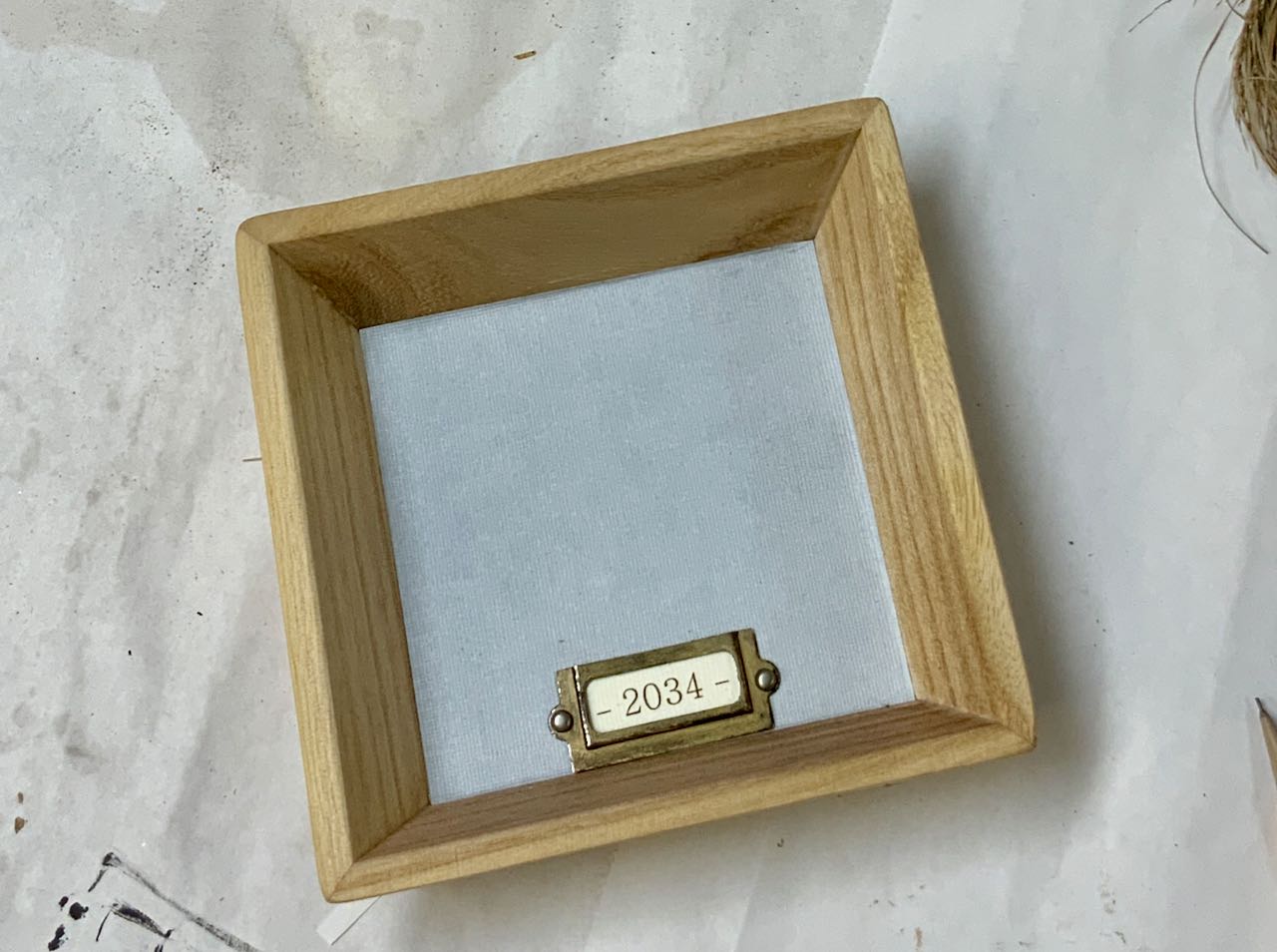 address label in metal holder centeredmat bottom of box