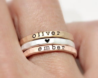 three thin rings stacked on a finger