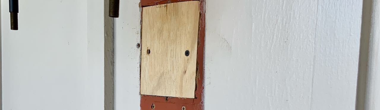 Super Closeup of Wood block filling hole in exterior wall