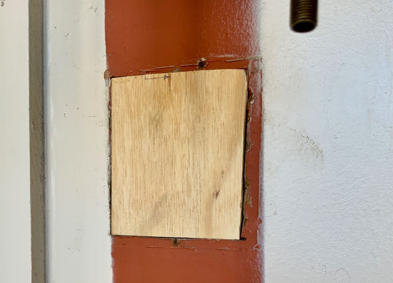 The freshly cut birch plywood is shown fitting just inside the hole