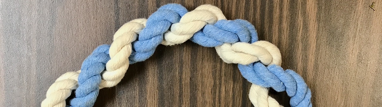 Closeup of Arch of Blue and natural rope twisted together