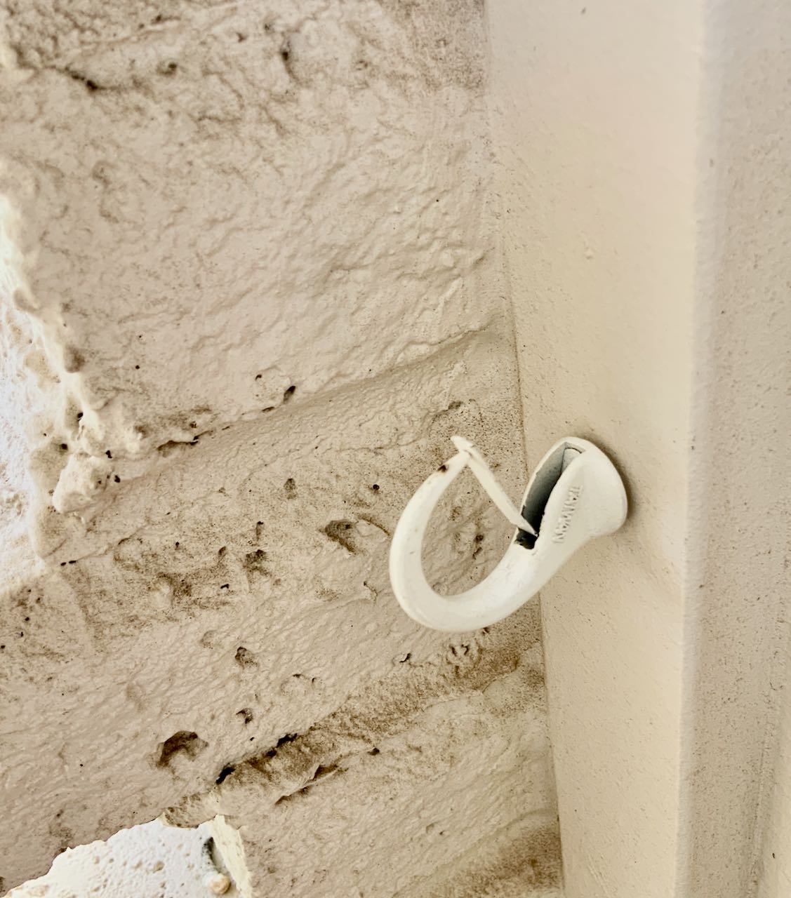 secure cup hook is screwed into the wall
