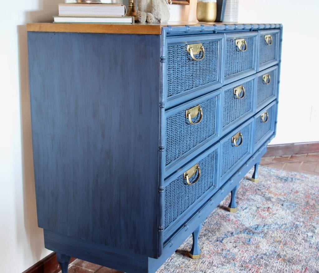 view of the side of the blue chest with the golden brown wood top showing