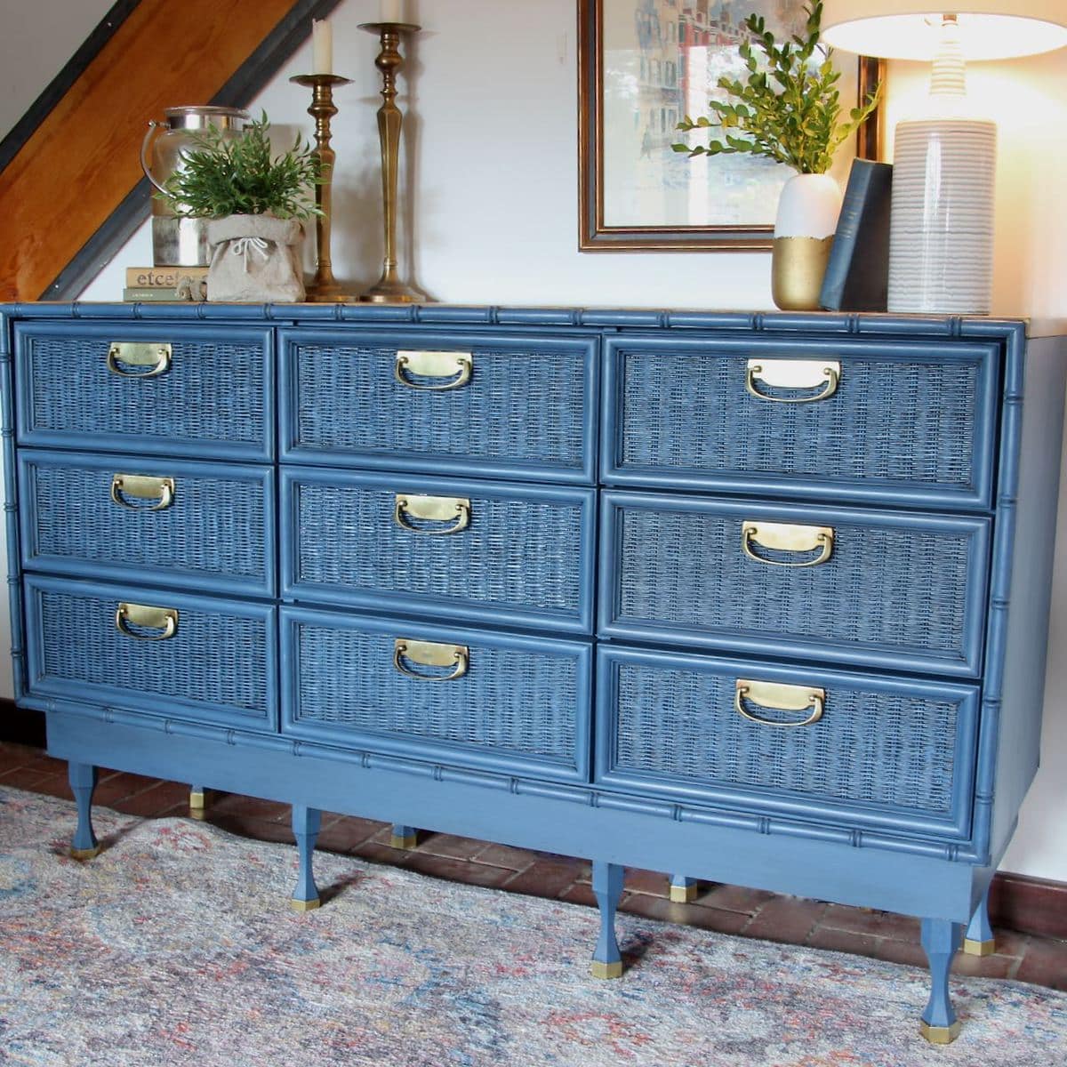 View of painted wicker chest with added legs and shiny brass pulls
