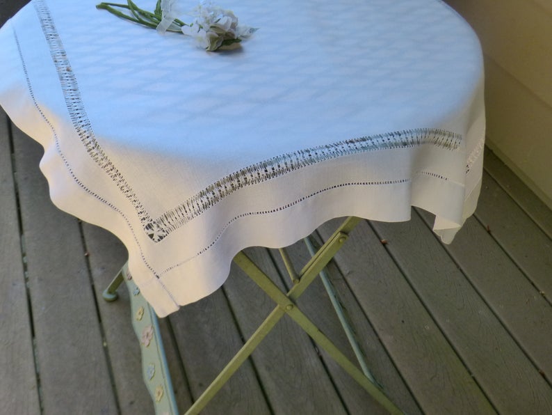 vintage outdoor table with a vintage linen table square with delicate hemstitching
