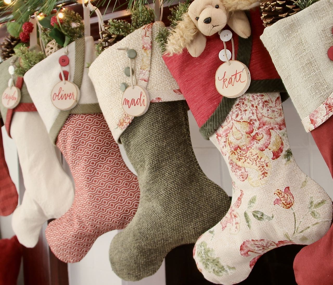 closeup of three Cottage Christmas Stockings with birch tree slice name tags