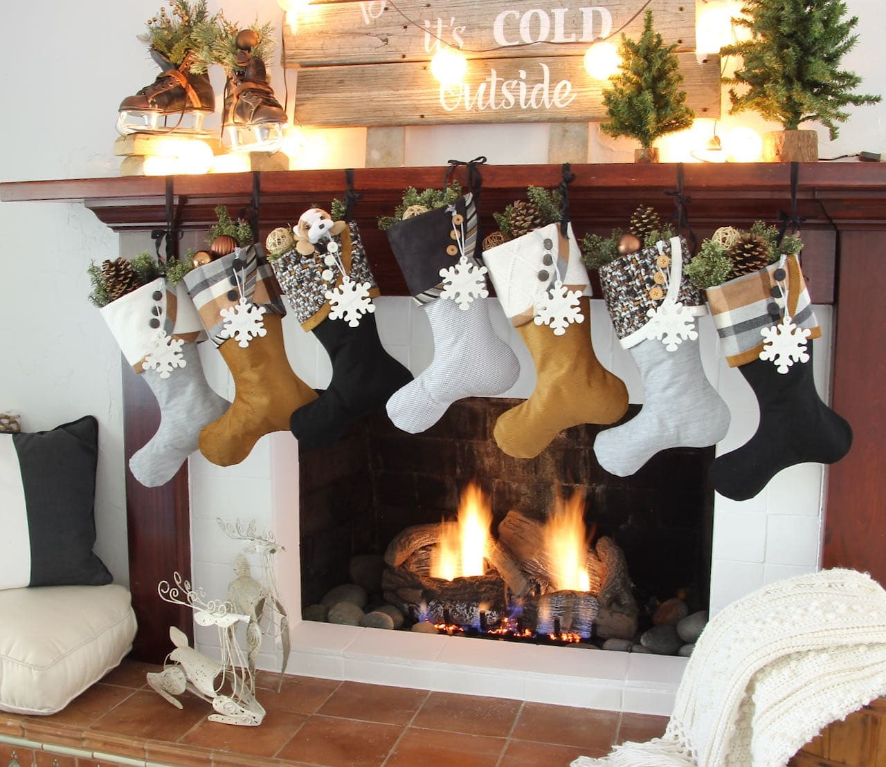 Cozy Copper Christmas Stockings with snowflake name tags hanging on a mantel with a fire roaring below and