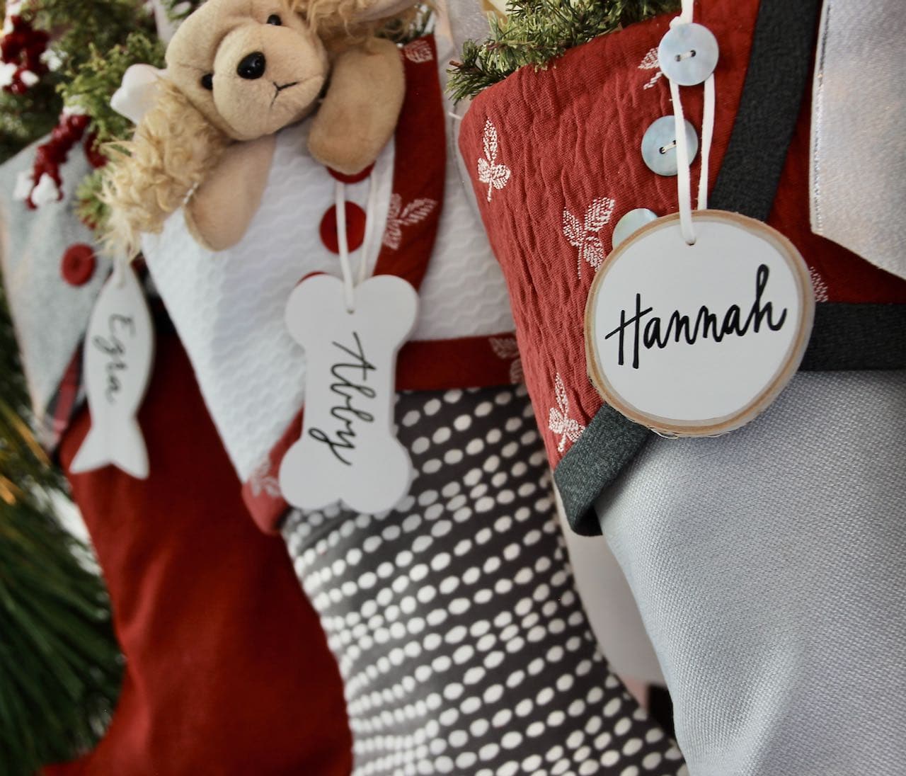 Closeup of 3 Preppy Christmas stockings with white name tags