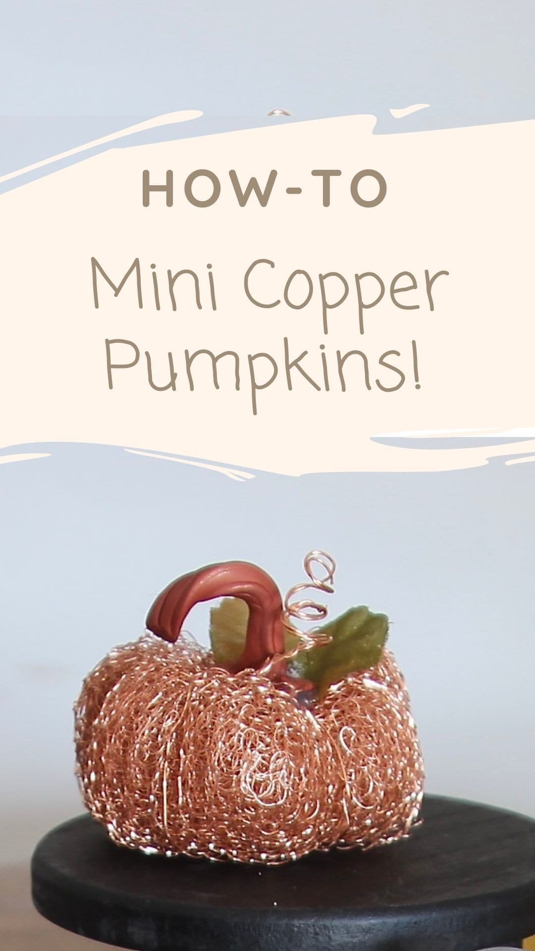 Pinterest pin showing one copper metal pumpkin on a black riser with the title "How-To Mini Copper Pumpkins"