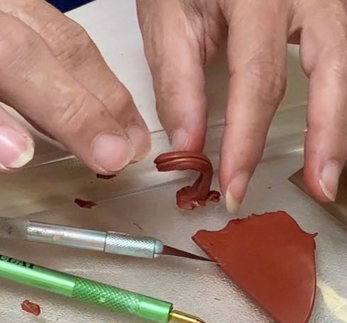 handing standing the faux stem on a glass plate and twisting and bending it into shape