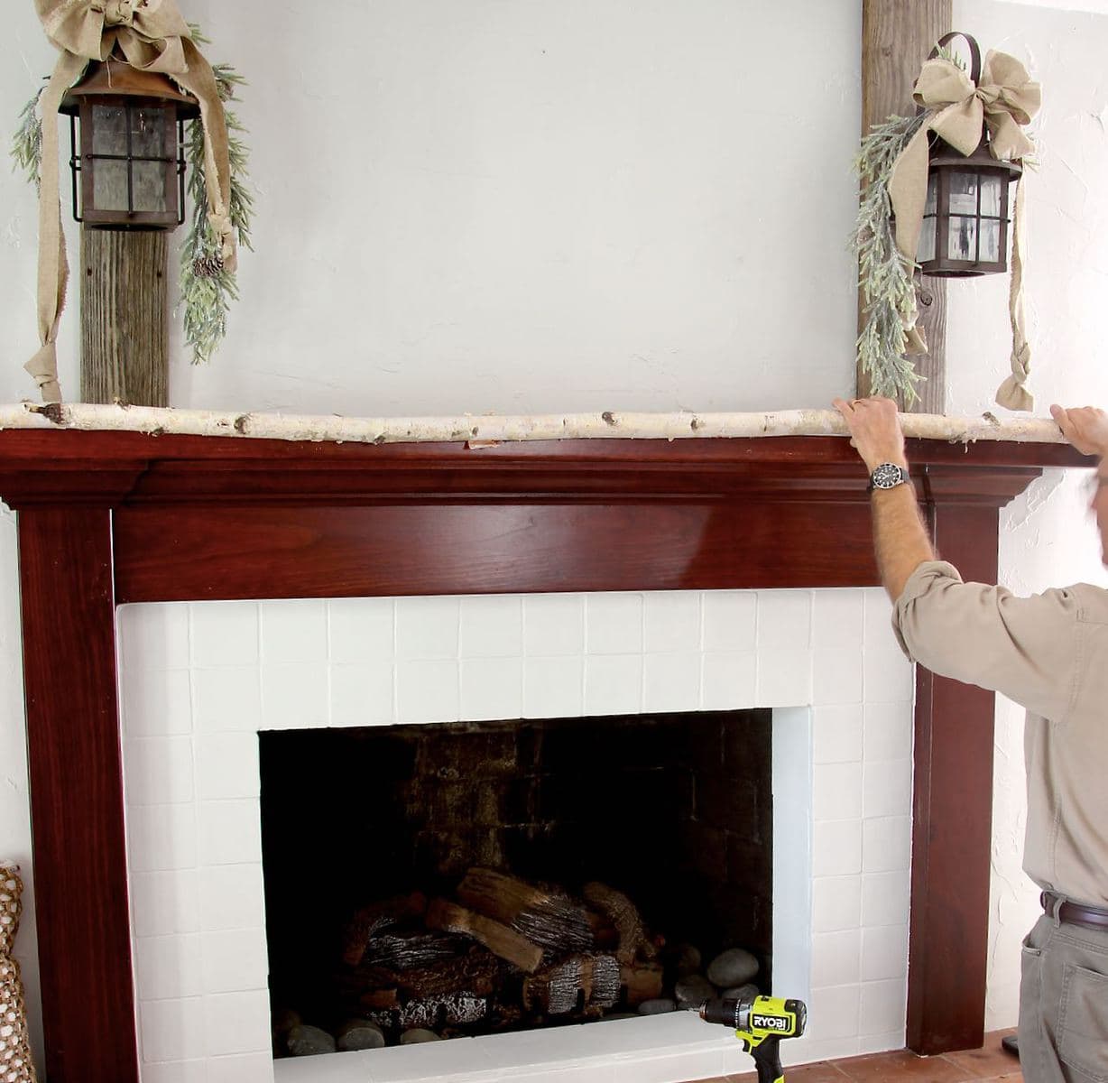 Image of a man hold the birch branch along the mantel